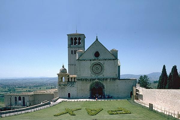 Basilika des Heiligen Franziskus von Assisi, Italien, von einer Rasenfläche aus gesehen. 