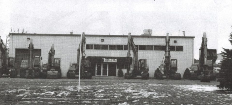 A black and white photo of a large building with a sign that says ' warehouse ' on it