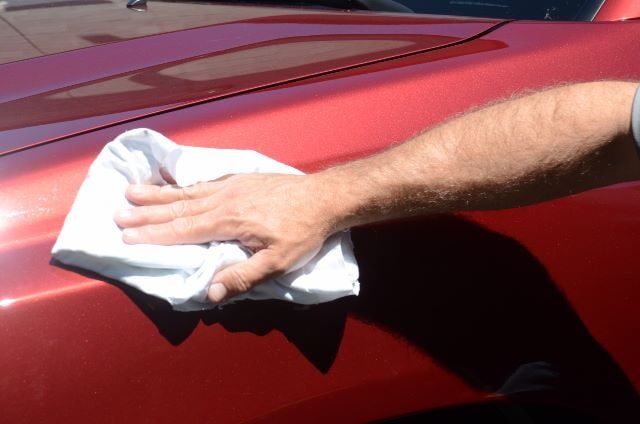 Man Cleaning a Car with a Cloth — Auto Repair in Braintree,, MA