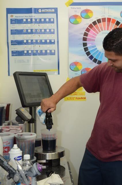 Man Pouring a Color Paint — Auto Repair in Braintree,, MA