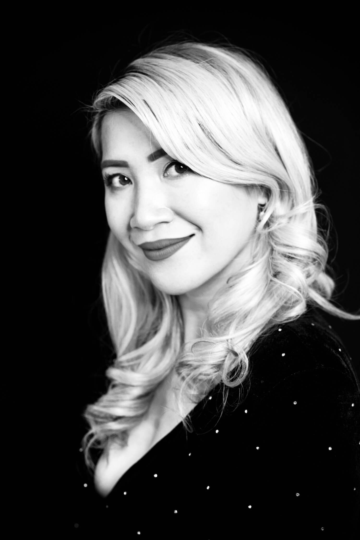 A black and white photo of a woman with long blonde hair.