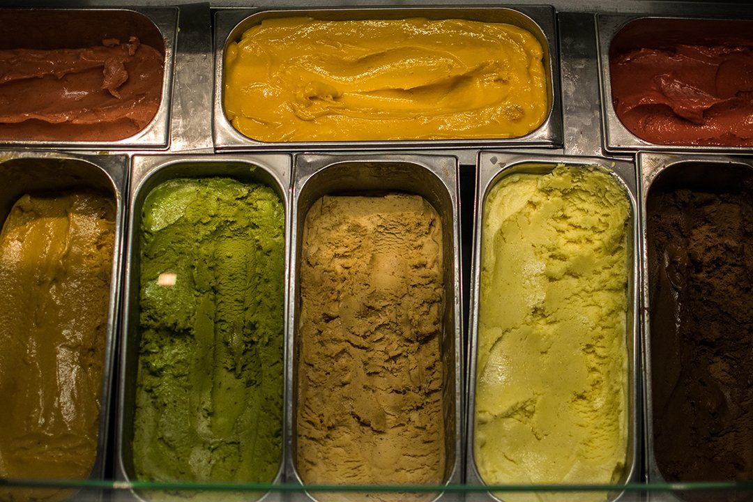there are many different flavors of ice cream in the containers .
