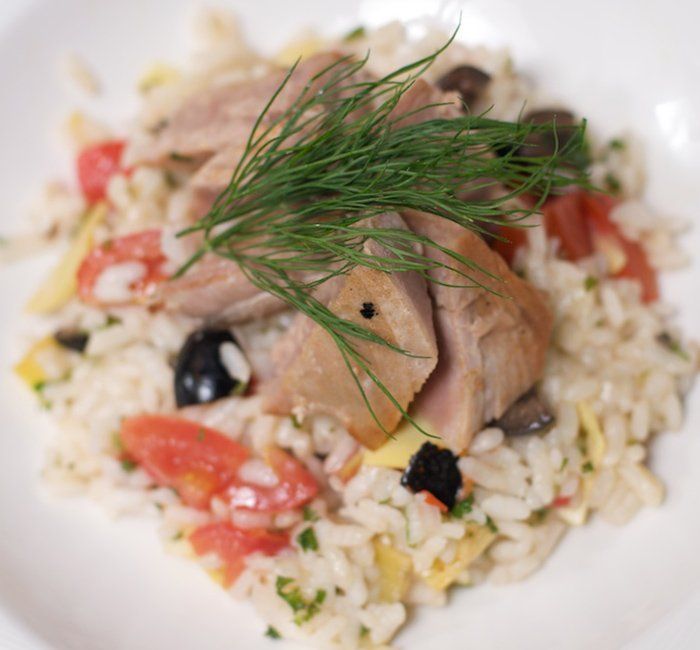 a close up of a plate of food with rice and meat