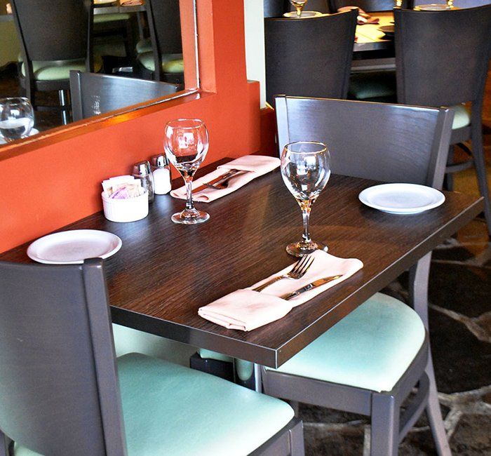 a restaurant table with plates and glasses on it