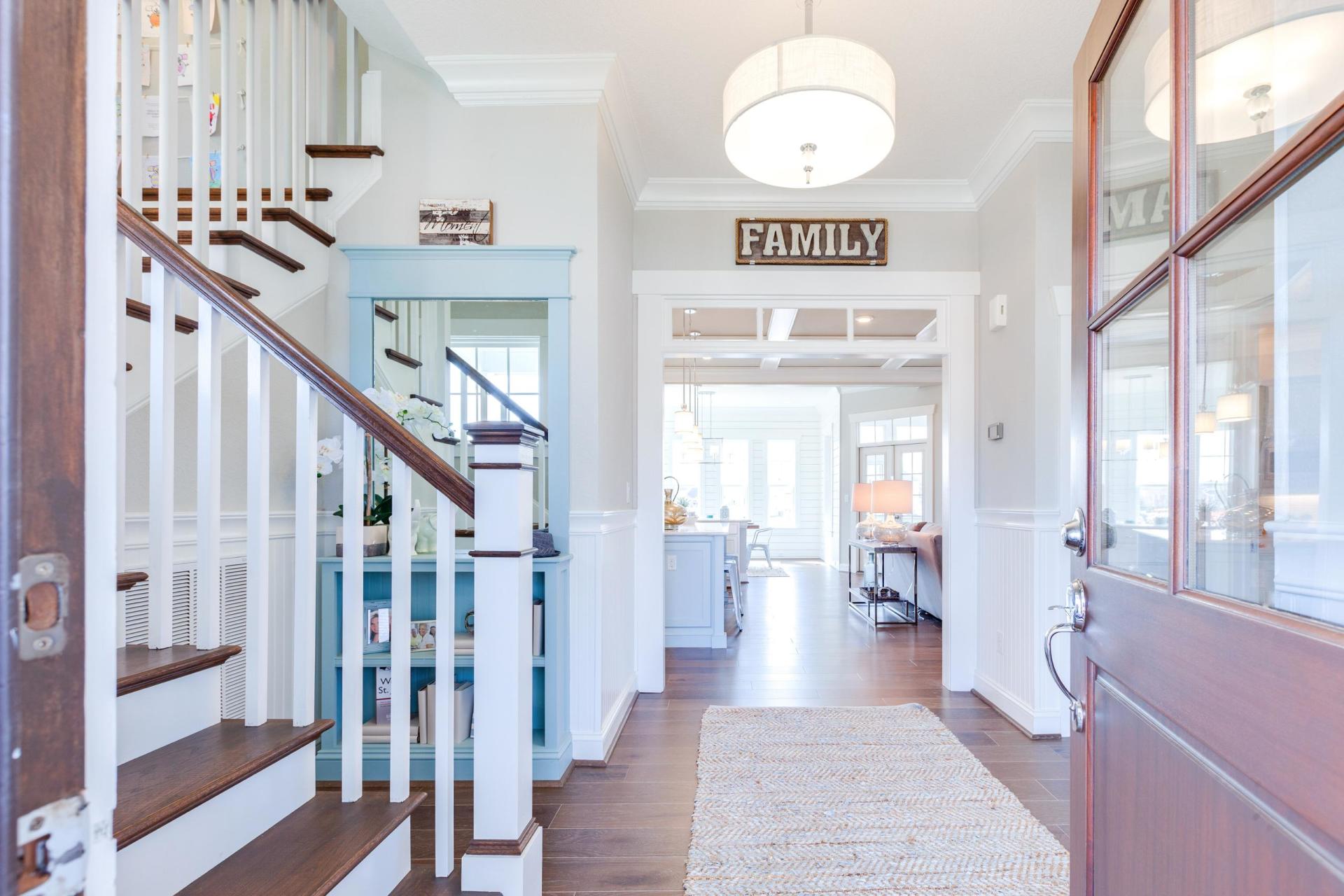 Hallway of elegant living area with view of staircase  | Living Spaces Gallery | Stephen Alexander Homes | Chesapeake, VA