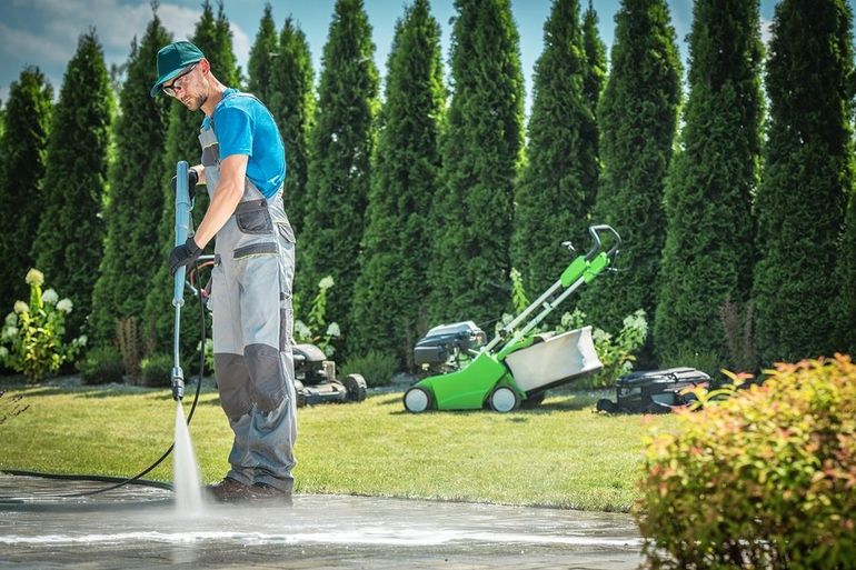 man spraying water in the ground