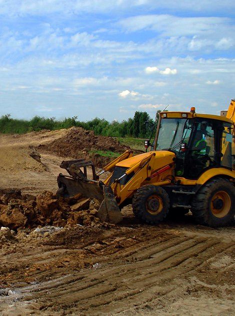 Heavy Equipment — Yellow Backhoe on Construction Site in Canastota, NY Heavy Equipment — Yellow Backhoe on Construction Site in Canastota, NY