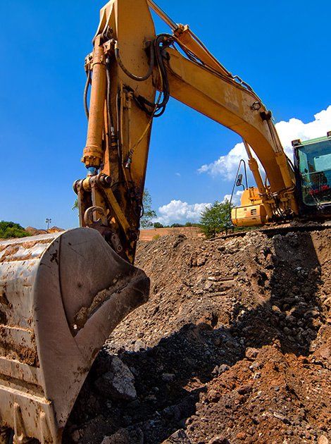 Rasmussen Excavation — Yellow Excavator Moving Soil in Canastota, NY Rasmussen Excavation — Yellow Excavator Moving Soil in Canastota, NY