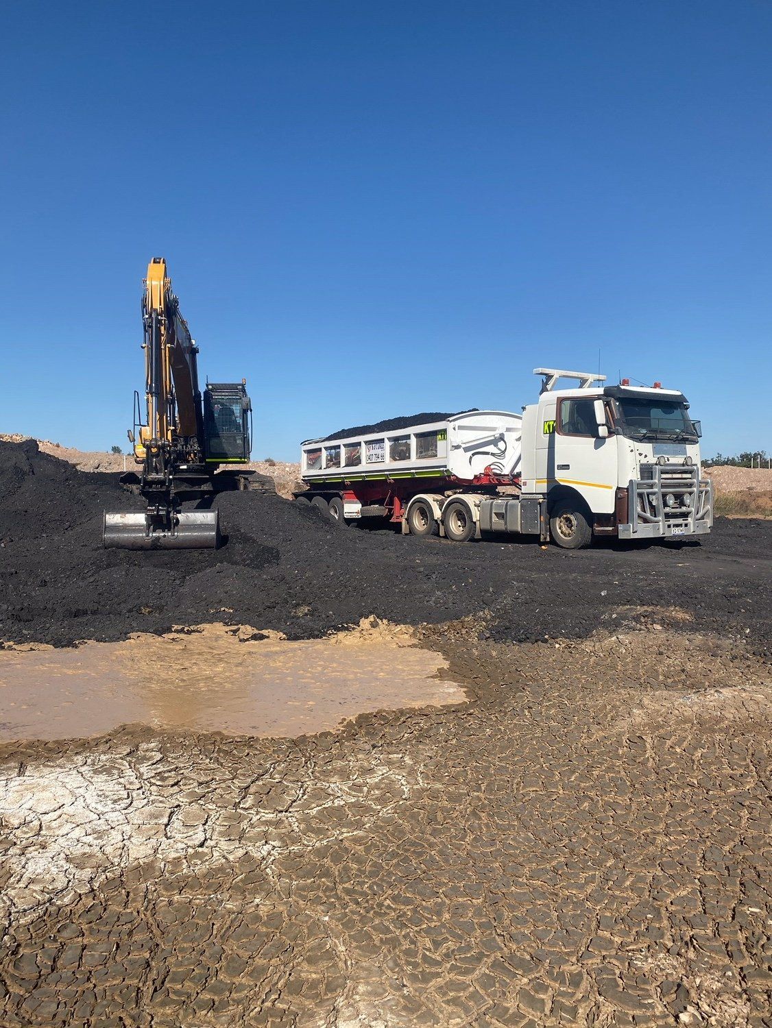 Excavator Loading Sand On Truck — K & T Daley in Gracemere, QLD