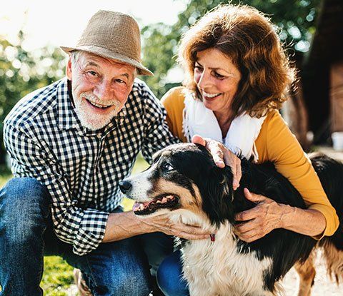 Pet Boarding — Senior Couple with Their Dogs in Blair, NE Pet Boarding — Senior Couple with Their Dogs in Blair, NE