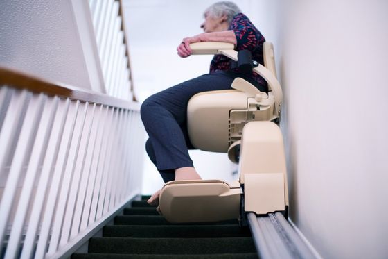 Senior Sitting on Stair Lift — Minneapolis, MN — Independent Living Solutions