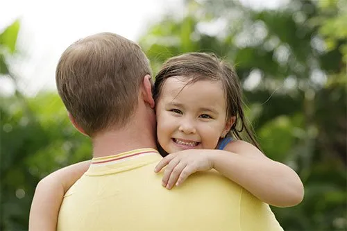 Father carrying his daughter