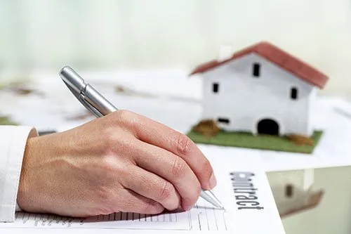Man signing on a contract