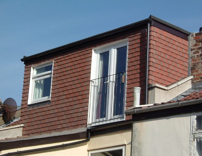 A building with a balcony on the top of it
