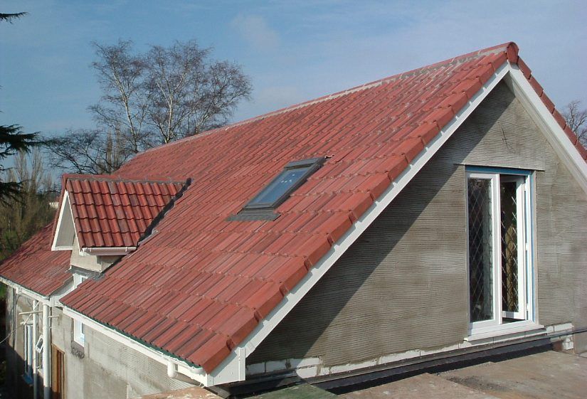 A house with a red tiled roof and a skylight