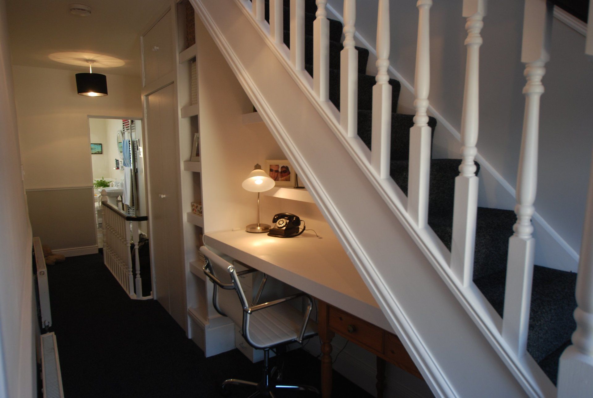 A loft stairs with a desk underneath it