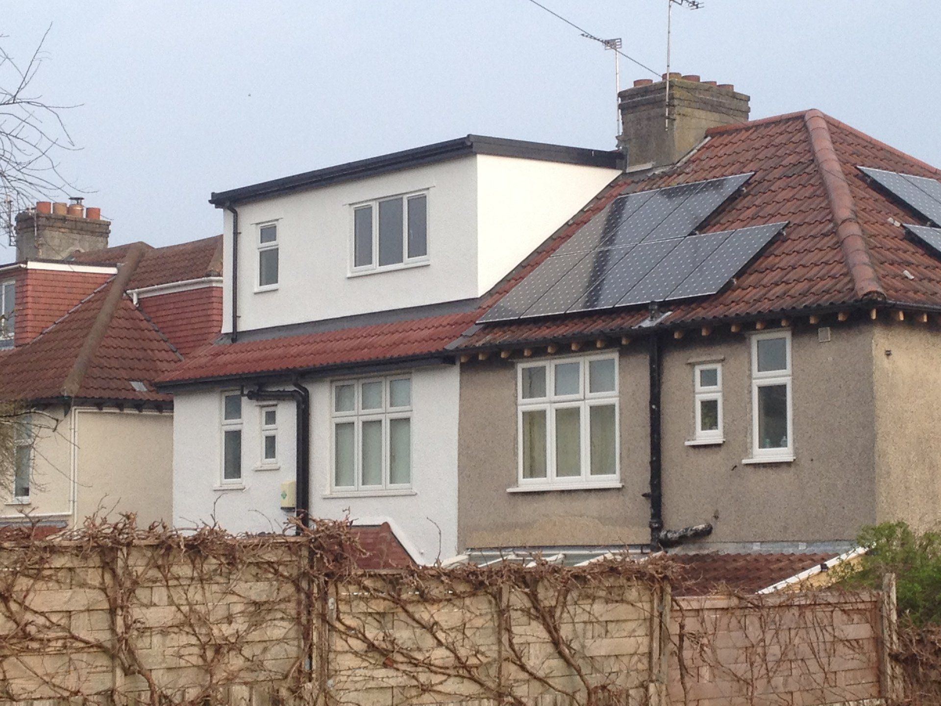 A row of houses with solar panels on the roofs