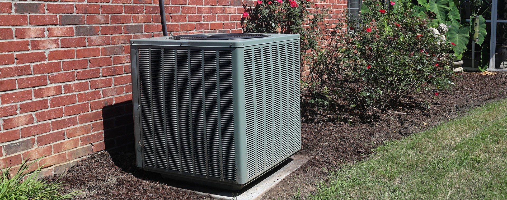 Home HVAC Unit next to modern brick home
