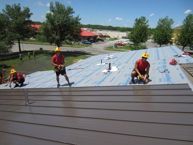 Roofing installing shingles on roof