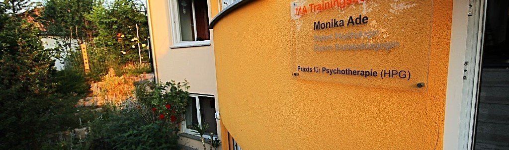 Ein gelbes Gebäude mit einem Schild an der Seite, auf dem 