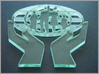 Mint-green cutout of two hands holding a group of people inside an oval frame.