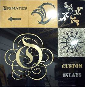 Collage of black and gold custom inlay designs, including flourishes, a starburst, and the word “Primates”