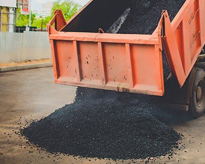 Stamped Asphalt — Truck Unloading Fresh Asphalt in North Canton, OH Stamped Asphalt — Truck Unloading Fresh Asphalt in North Canton, OH