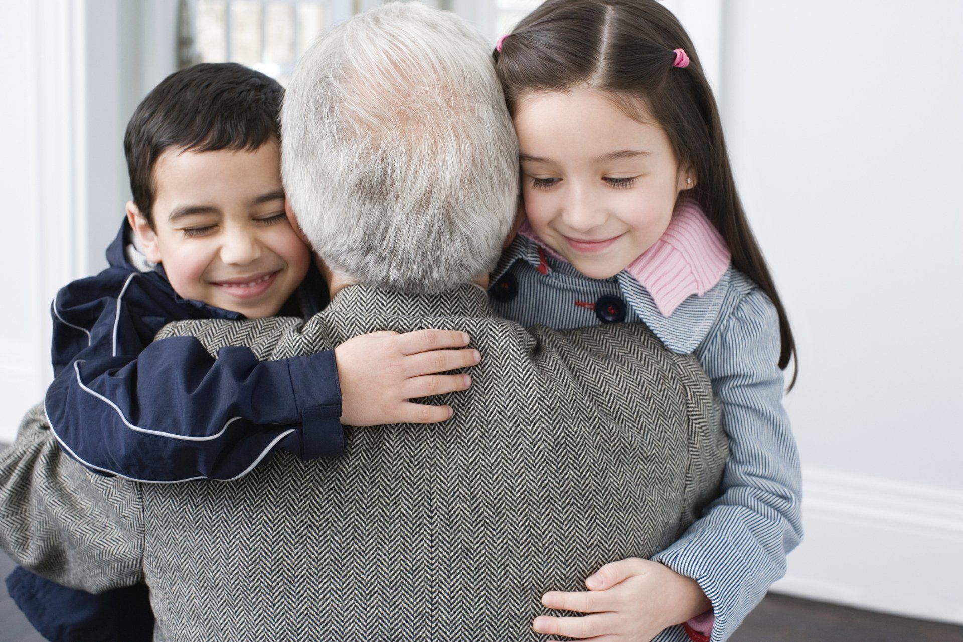Grandparent hugging grandchildren