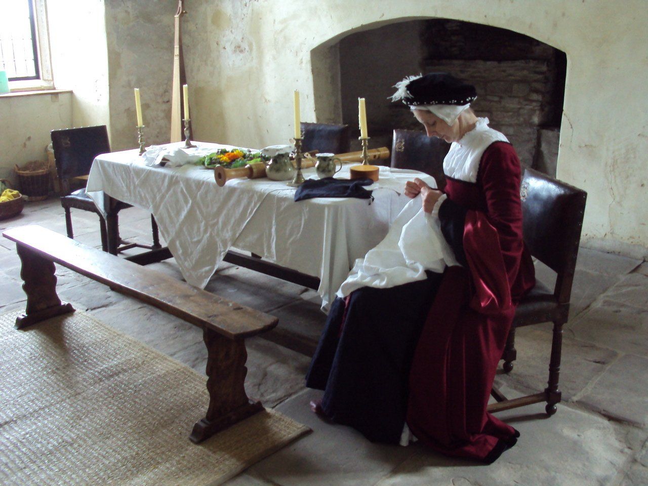 A woman in a red dress is sitting at a table