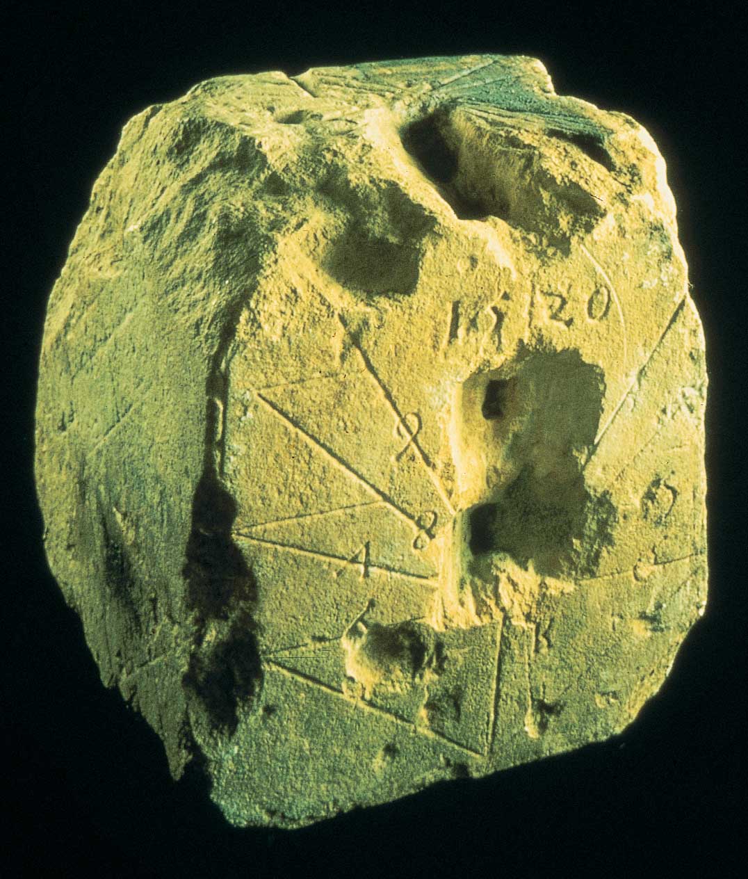 A piece of rock with a hole in it and the number 1510 on it