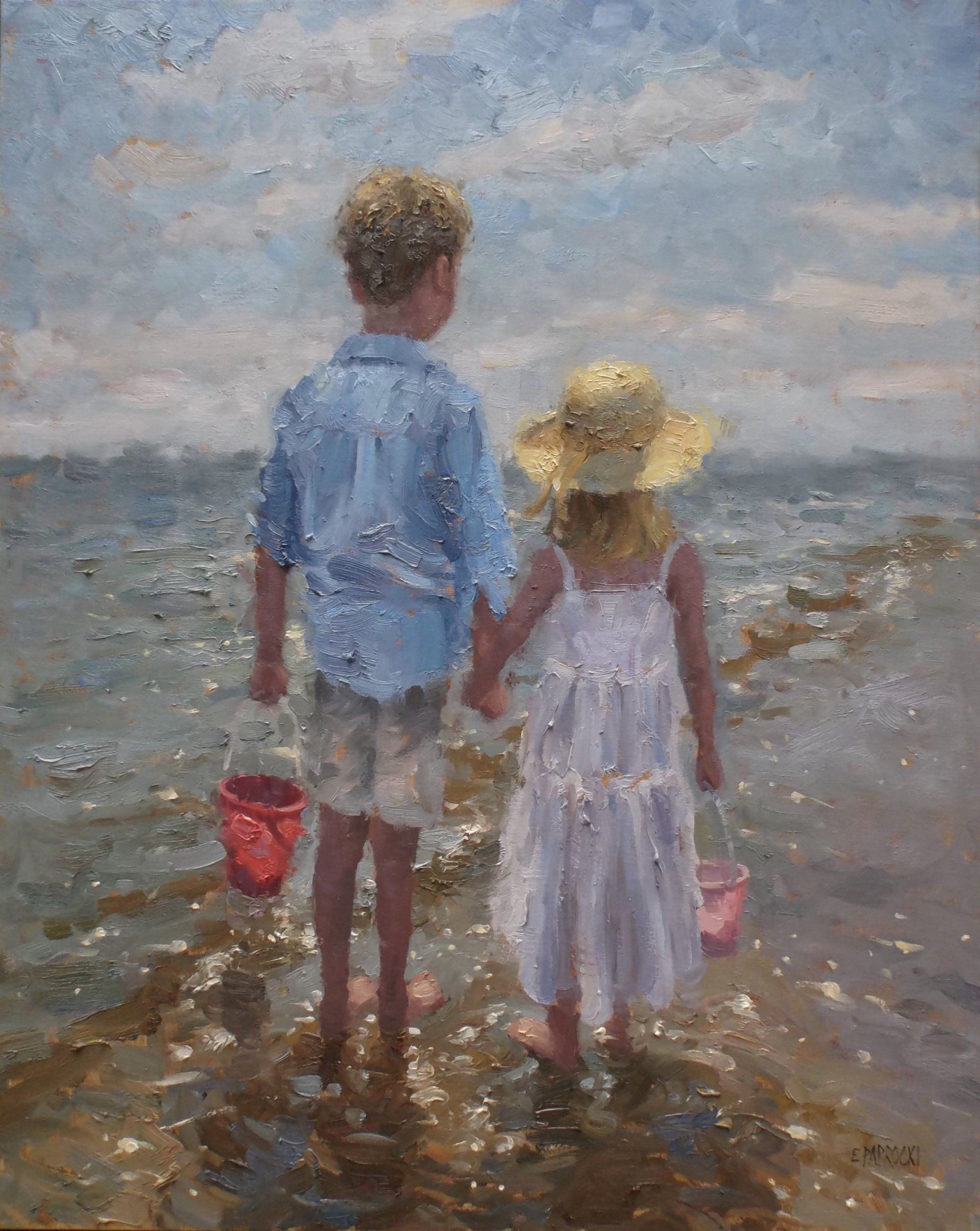 A boy and a girl are walking on the beach holding hands.