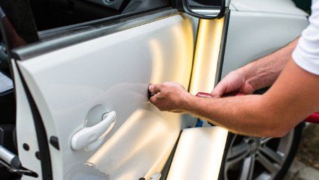Man Doing Paintless Dent Repair — Buffalo, NY — Clinton Collision