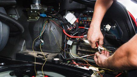 Electrician Works With Electric Block in Car — Buffalo, NY — Clinton Collision Electrician Works With Electric Block in Car — Buffalo, NY — Clinton Collision
