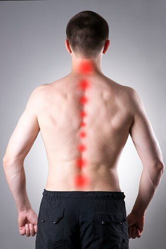 A man showing a spine pain illustration — Jersey City, NJ — Pain and Disability Institute A man showing a spine pain illustration — Jersey City, NJ — Pain and Disability Institute