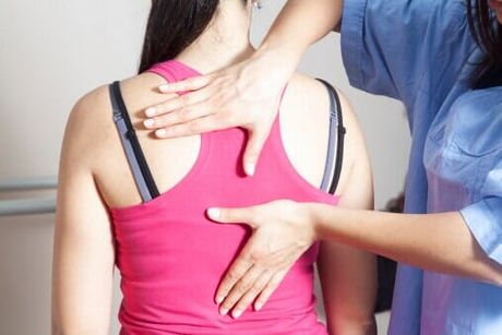Woman having a back pain checkup — Jersey City, NJ — Pain and Disability Institute Woman having a back pain checkup — Jersey City, NJ — Pain and Disability Institute