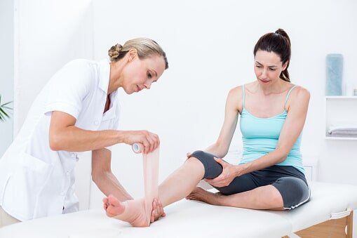A nurse putting bandage to a woman's foot — Jersey City, NJ — Pain and Disability Institute A nurse putting bandage to a woman's foot — Jersey City, NJ — Pain and Disability Institute