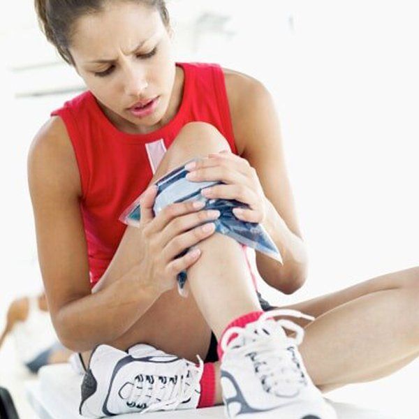 Athlete putting ice bag on her bruise — Jersey City, NJ — Pain and Disability Institute Athlete putting ice bag on her bruise — Jersey City, NJ — Pain and Disability Institute