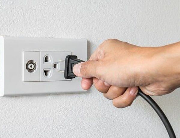A man plunging a plug into the socket — Jersey City, NJ — Pain and Disability Institute A man plunging a plug into the socket — Jersey City, NJ — Pain and Disability Institute