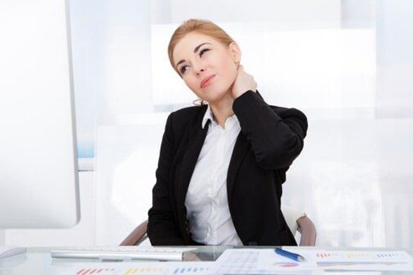 A woman in the office having neck pain — Jersey City, NJ — Pain and Disability Institute A woman in the office having neck pain — Jersey City, NJ — Pain and Disability Institute