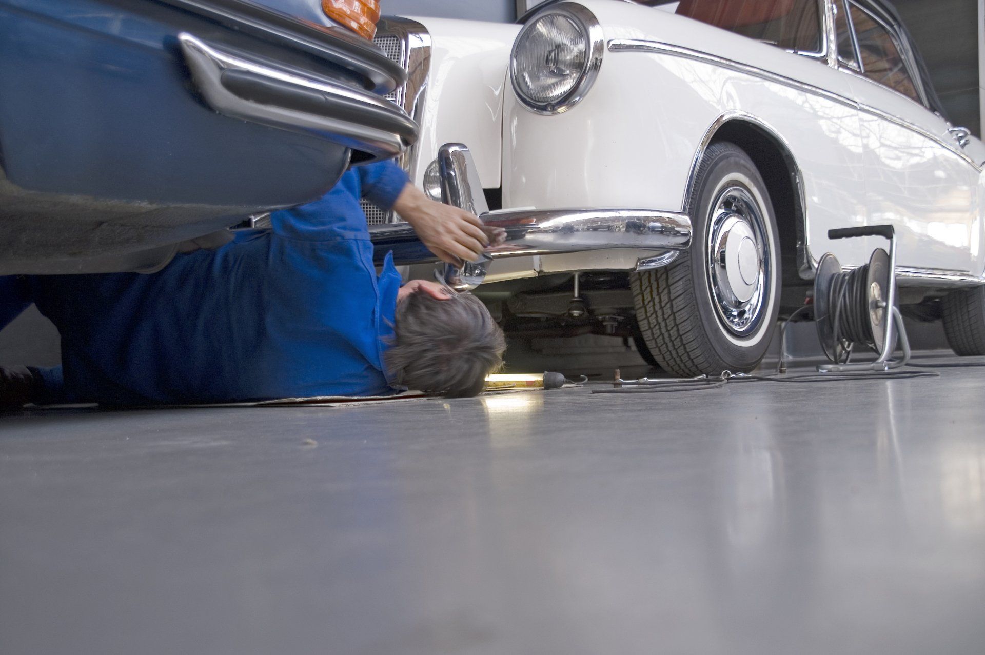 Mechanic Lying Under Car And Working With Tools — Branford, CT — Paul’s Auto Service