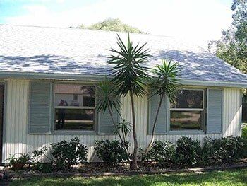 Hurricane Shutters Ormond Beach FL — House with Colonial Shutter in Ormond Beach, FL