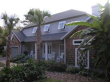 Hurricane Shutters Ormond Beach FL — Brown House with Bahama Shutter in Ormond Beach, FL