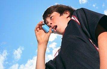 Kid taking Inhaler — Allergy Clinic in Idaho Falls, ID