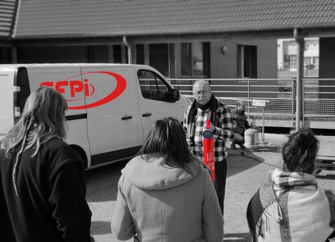 Photo de formation incendie dehors avec pratique avec extincteurs pour éteindre les départ de feu dans un entreprise par les salariés.