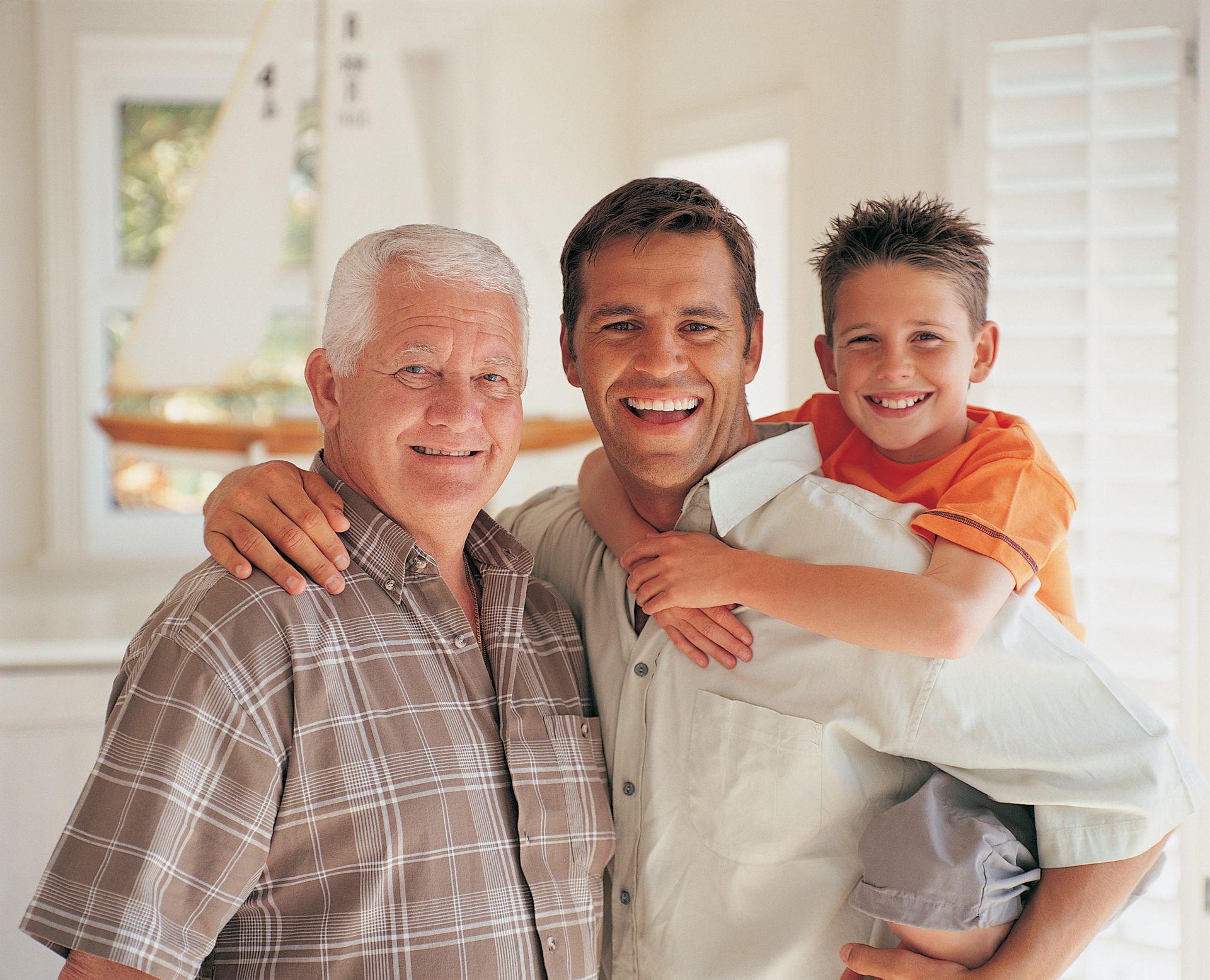 Two men and a boy are posing for a picture together