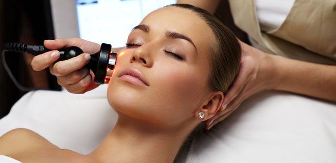 A woman is getting a facial treatment at a spa.