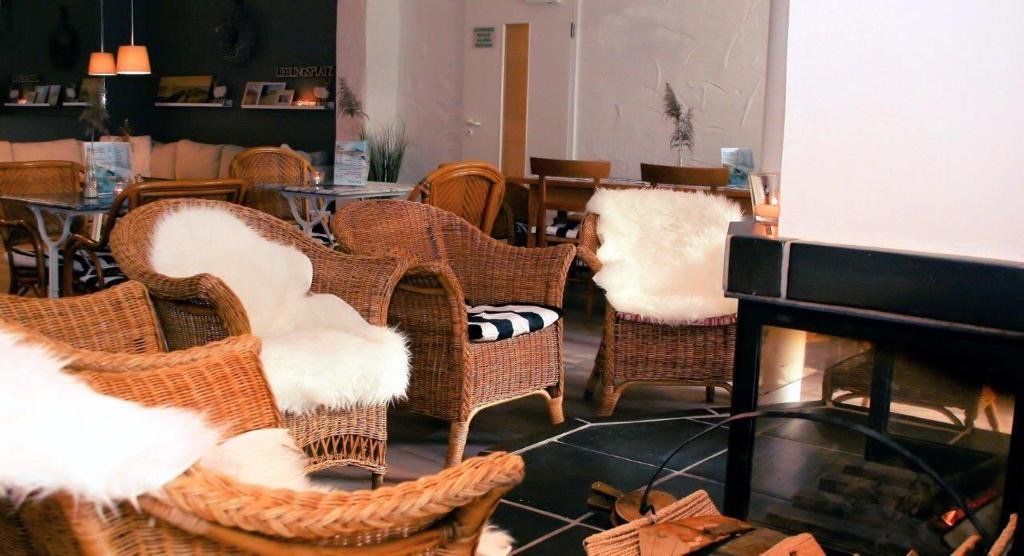 Ein Wohnzimmer mit Korbstühlen und Kamin