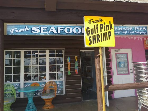 Seafood shop exterior with a sign advertising