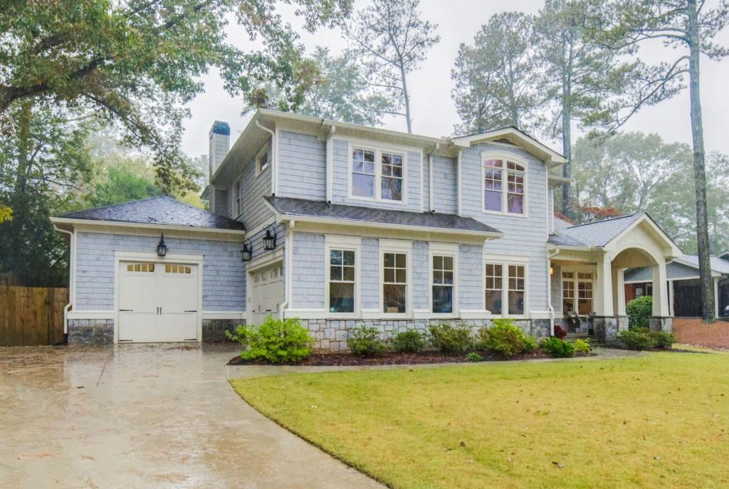 A large house with a lot of windows and a garage