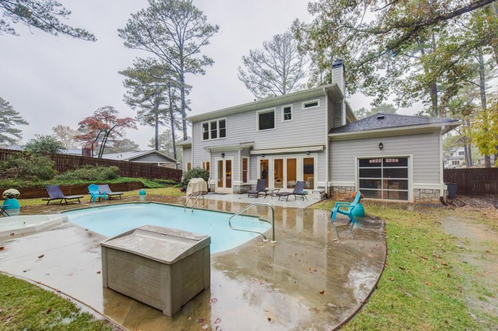A large house with a large swimming pool in the backyard.